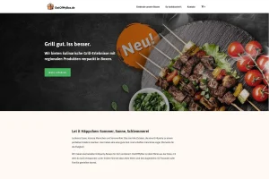Die Website von Out Of My Box, die einen Teller mit gegrillten Spießen und Gemüse zeigt